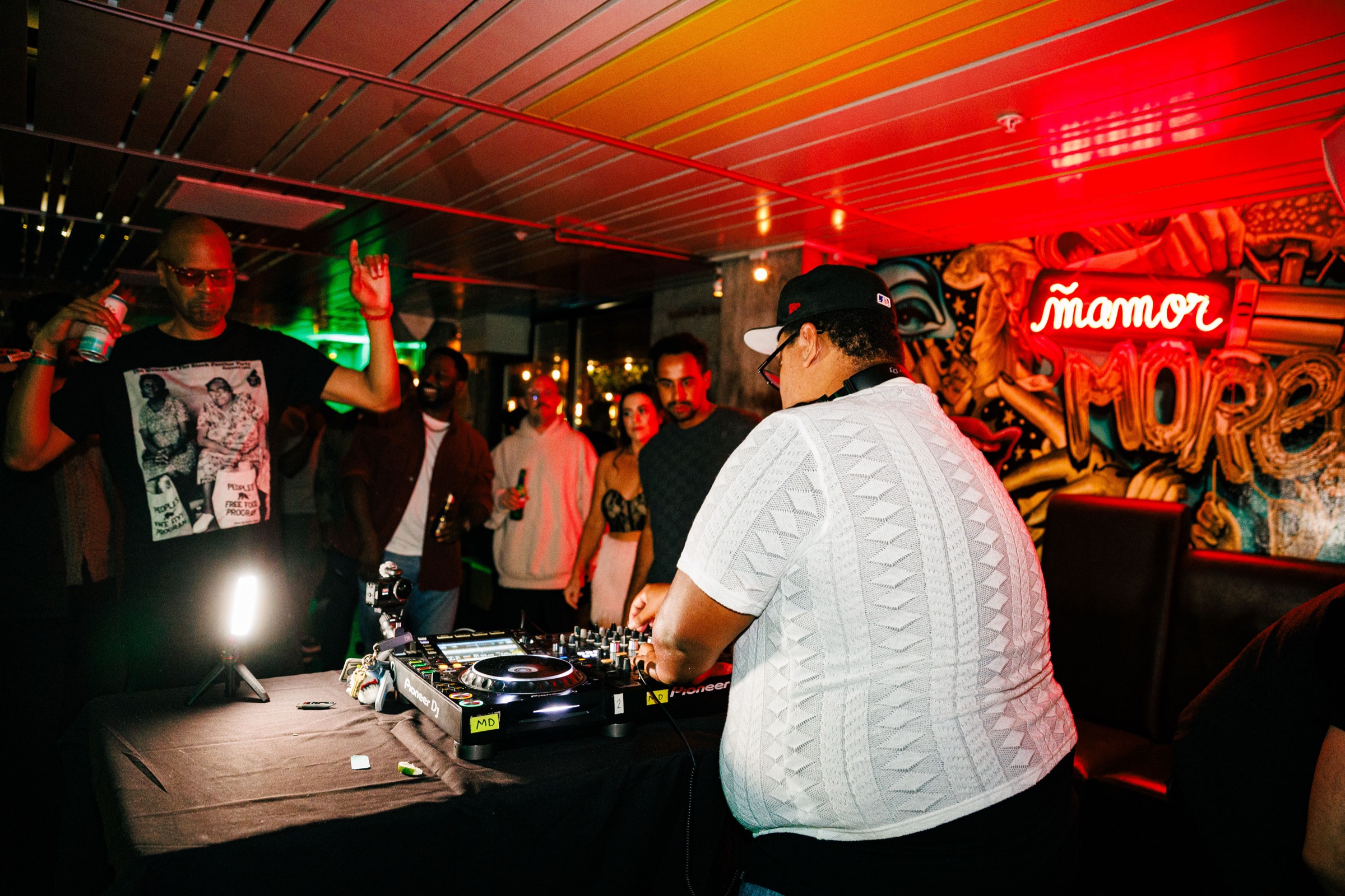A DJ plays while people gather nearby at 620 Jones